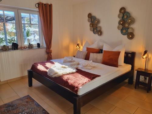 a bedroom with a bed with pillows on it at Eifel Dream Kleinenims in Burbach