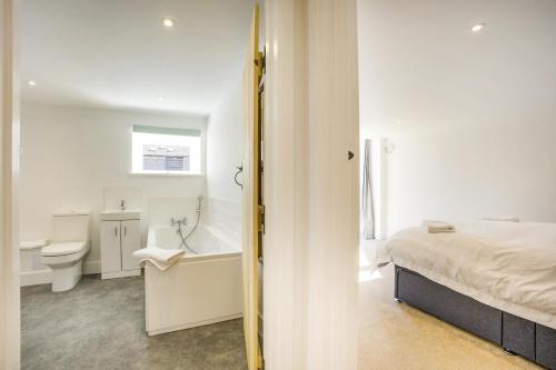 a white bathroom with a bed and a tub and a toilet at 1 Bed in Barrow oc-b42641 in Barrow