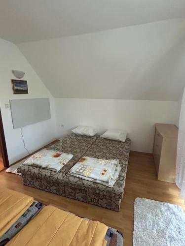 a small bedroom with a bed in a room at Stella apartman in Gabčíkovo