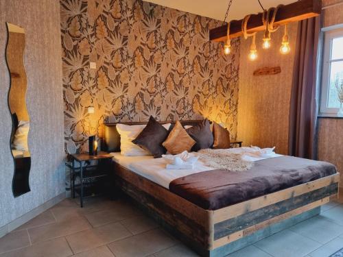a bedroom with a large bed in a room at Eifel Dream Casa29 in Burbach