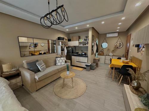 a living room with a couch and a table at Qerret Boutique Studio Apartment in Golem