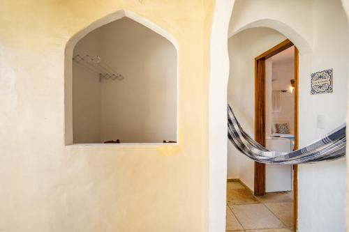 a hallway with a mirror on the wall at Villa Medina Oasis in Jericoacoara