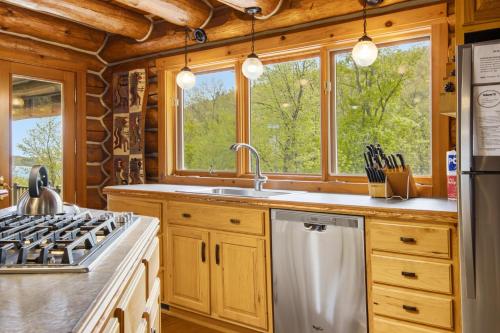 a kitchen with wooden cabinets and a sink and a stove at Viewtopia in Suttons Bay