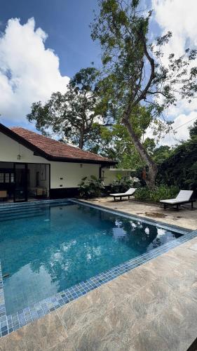 a swimming pool in front of a house at Heritage Villa - 05 Bedroom Family Villa in Central Ahangama in Ahangama