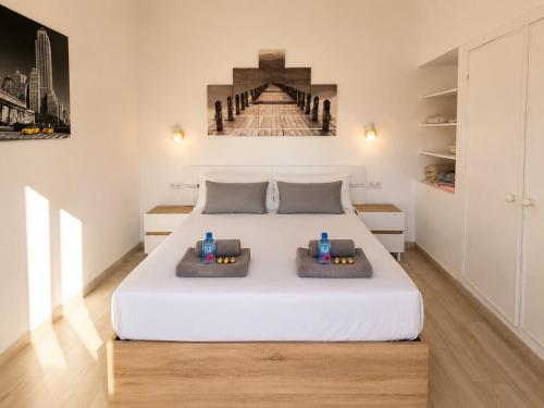 a bedroom with a large white bed with two pillows at Sunny Bungalow with Pool & Patio in Sonnenland By Canarias Prime Homes in Maspalomas