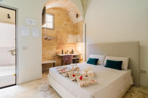 a bedroom with a bed with towels on it at Luxury Rooms in Alezio