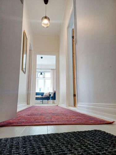 an empty hallway with a red rug on the floor at Exclusive Luxury Apartment with free private parki in Aalborg