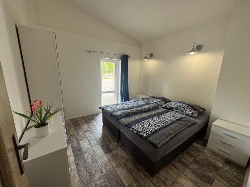 a bedroom with a bed and a window at Ranč v Landu in Kamýk nad Vltavou