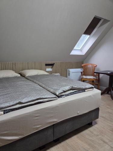 a bedroom with a bed and a table and a window at Erve Ther Maet in Weerselo