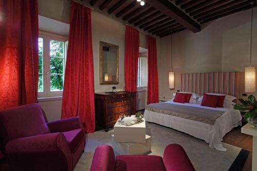 a bedroom with a bed and red curtains at Villa Benveduti in Gubbio