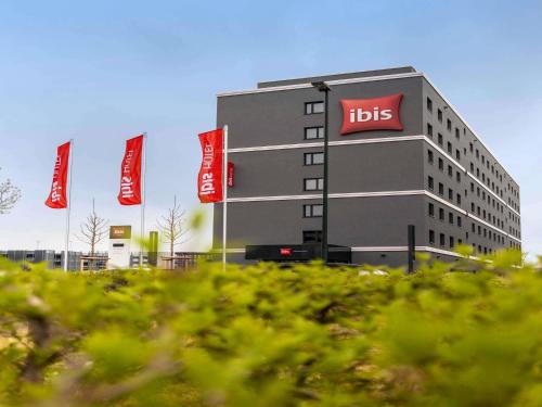 a tall building with aits signs in front of it at ibis Duesseldorf Airport in Düsseldorf