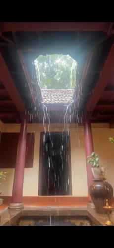a ceiling with a water fountain in a room at Warriam Road in Chottanikara