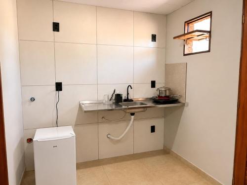 a small kitchen with a sink and a counter at Pousada Serena Jacumã in Jacumã
