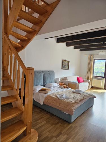 a bedroom with a bed and a stair case at Belvedere Chalet Bran in Bran