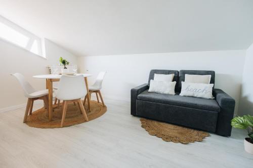 a living room with a table and a couch at Casa Anastasia Beach Loft in Montesilvano