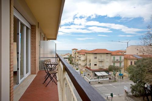 a balcony with a view of a city at Casa Gorgone, SeaFront Flat! in Viareggio