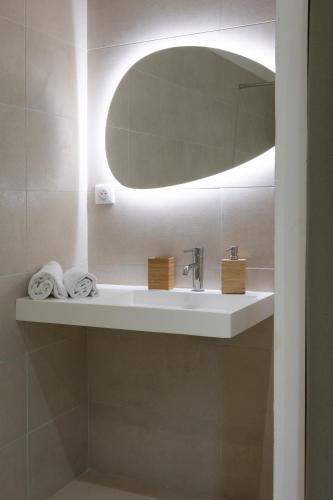 a bathroom with a sink and a mirror at Casa Marina Cargèse in Cargèse