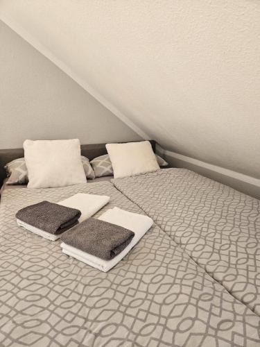 a bed with towels and pillows on top of it at Green Living in Meckenbeuren