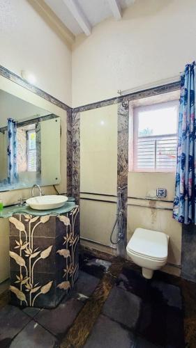 a bathroom with a sink and a toilet at Niwas Villa in Vihur