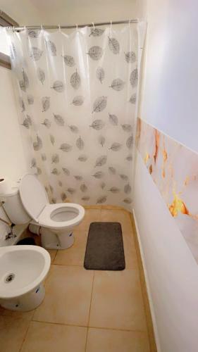 a bathroom with a toilet and a shower curtain at Meditation house in El Jadida