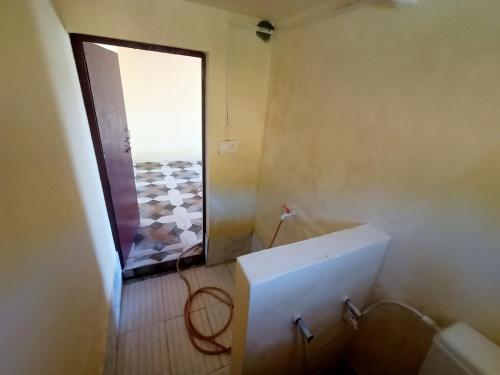 a bathroom with a window and a white tub at Almora Nainital-Kausani Highway Kosi Bazar in Almora