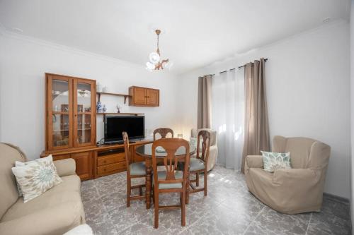 a living room with a table and chairs at En la Gloria in Barbate