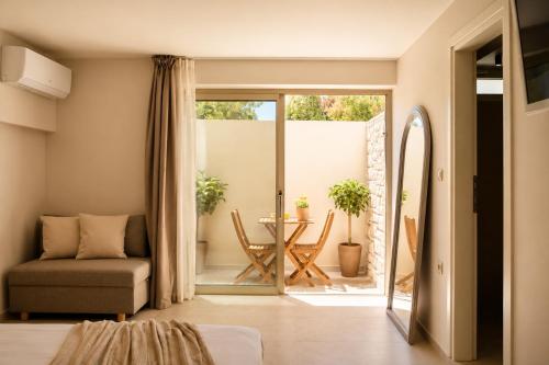 a living room with a couch and a chair and a table at Villa Pelagos in Koutsounari
