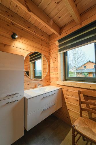 a bathroom with a sink and a window in a cabin at Gites de la Semois in Laviot