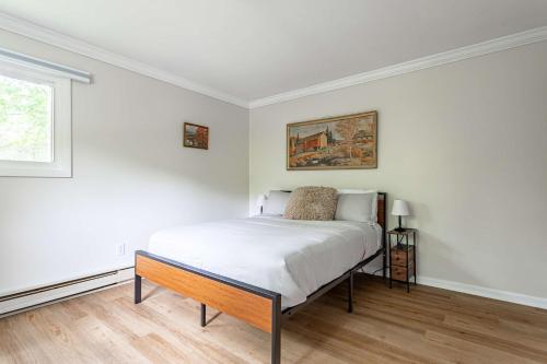 a white bedroom with a bed and a window at Sasquatch Hideaway Game Room Fire Pit in Mushroom Farms