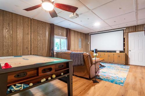 a room with a pool table and a projector screen at Sasquatch Hideaway Game Room Fire Pit in Mushroom Farms