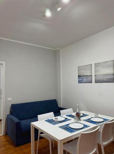 a living room with a table and a blue couch at Casa Tropea Vibes in Tropea