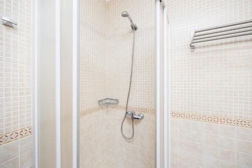a shower with a glass door in a bathroom at Villa Ponent in Port d'Addaia