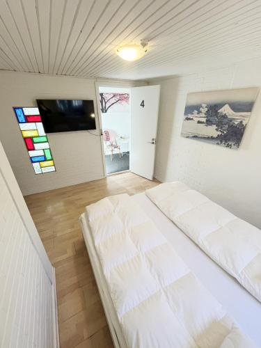 a bedroom with a white bed in a room at Central Large Double Room with free parking in Aalborg