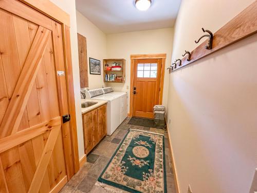 a kitchen with a wooden door and a sink at The Vines in Warren