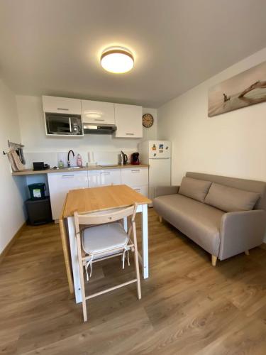 a living room with a table and a couch at Hulot-838-Iodine parenthesis in Frontignan