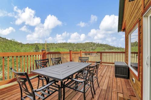 a wooden deck with a table and chairs on it at Cozy Deer Valley Cabin- Views Fireplace & Deck in Jefferson