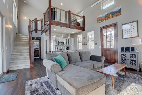 a living room with a couch and a staircase at Mountain Escape with Spectacular Views in Jefferson