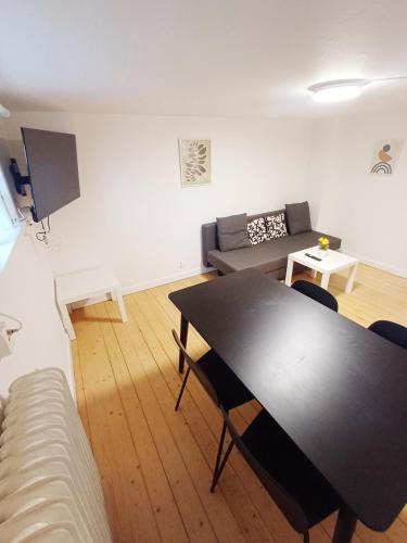 a living room with a black table and a couch at Central apartment in Aalborg close to Hospital in Aalborg