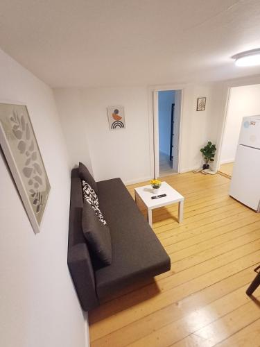 a living room with a couch and a table at Central apartment in Aalborg close to Hospital in Aalborg
