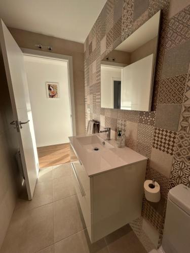 a bathroom with a sink and a mirror at TÍA NANDUCA in Liencres