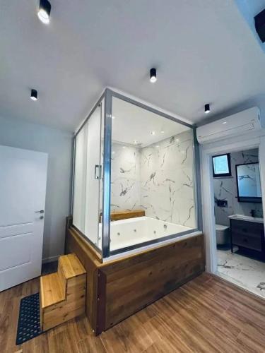 a large bathroom with a tub and a large window at Quba in Quba
