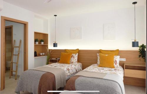 two beds sitting next to each other in a room at Mariposa in Marbella