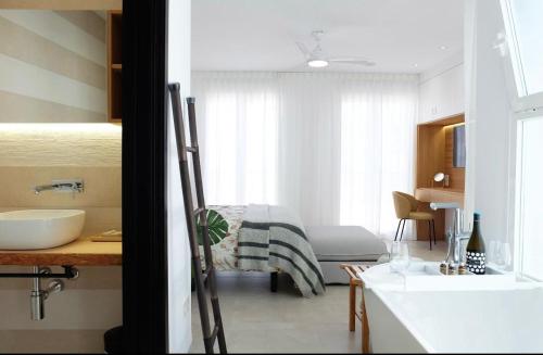 a bathroom with a bed and a sink in a room at Mariposa in Marbella