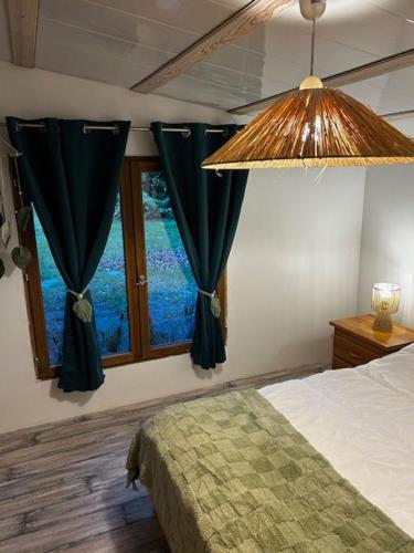 a bedroom with a bed and a window at Chalet à Biscarrosse in Biscarrosse