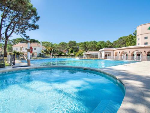 a large swimming pool with blue water at Del Pinar Apart in Costa del Este