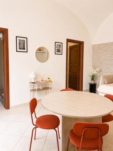 a living room with a table and chairs at Casa Corallium in Torre del Greco