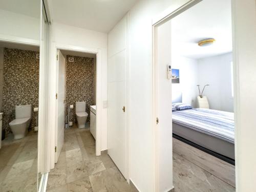 a bedroom with a bed and two toilets at Increíbles vistas al mar A102 in Torrox Costa