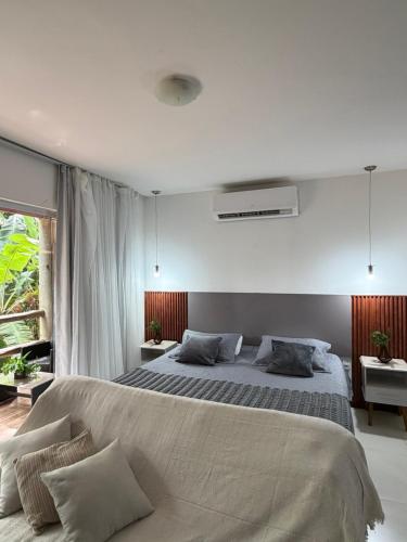 a bedroom with a large bed in a room at Villas do Pratagy Bambu 2 in Maceió