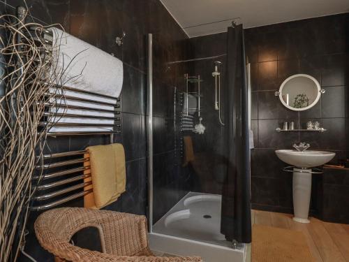 a bathroom with a shower and a toilet and a sink at Rollies Retreat in Fowey