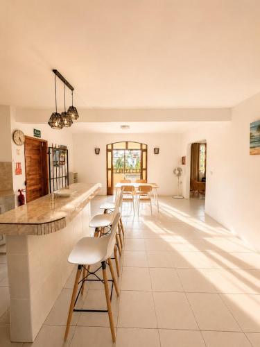 a kitchen with a counter and chairs in a room at Pointe D'Esny Villa 1 in Mahébourg